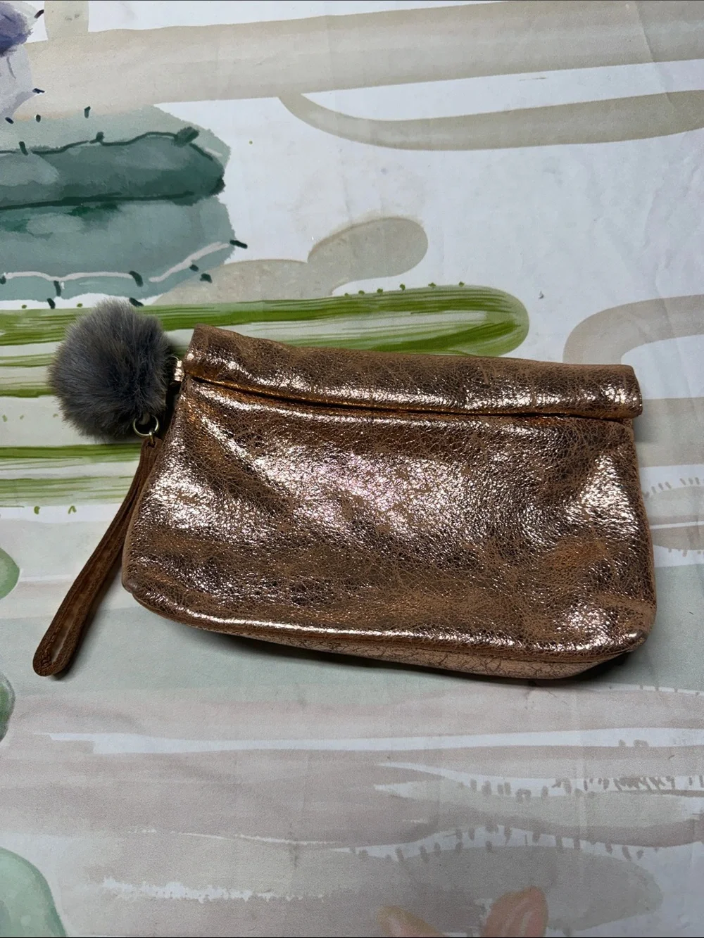 Miss Albright Metallic Rose Gold Wristlet Clutch with Pom Pom Accent